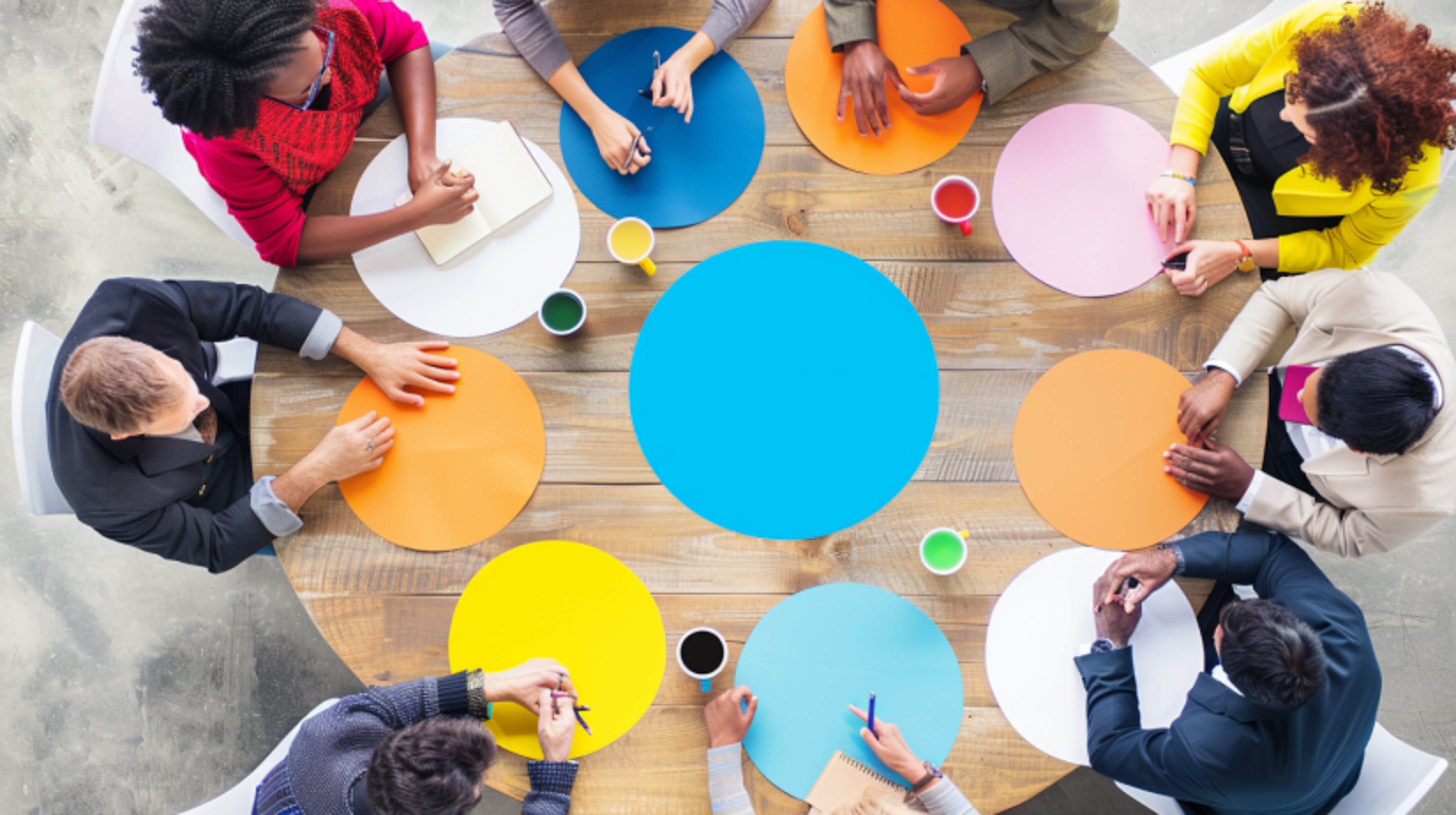 People sitting floor with different colored circles around them